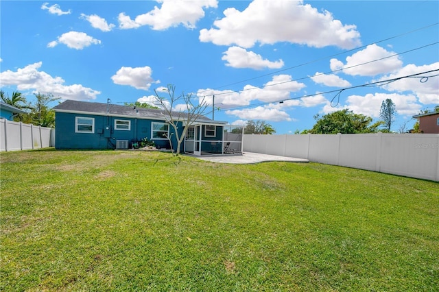 5367 5th Ave N, Saint Petersburg, FL 33710 - back of property with a sunroom, a patio, a fenced backyard, central AC, and a lawn