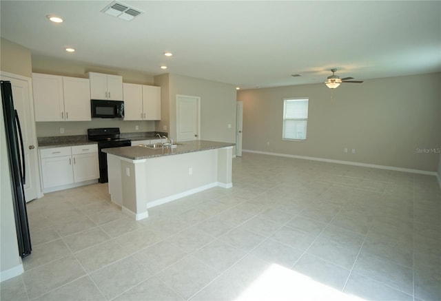 1038 Ocean Spray Dr, Ruskin, FL 33570 - kitchen with black appliances, a sink, white cabinets, open floor plan, and a ceiling fan