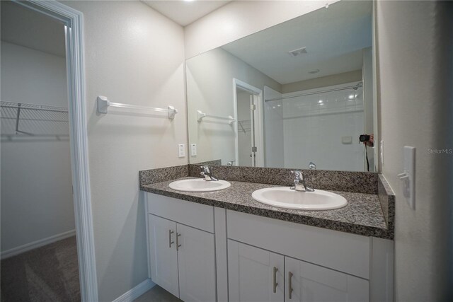 1038 Ocean Spray Dr, Ruskin, FL 33570 - full bath with a walk in closet, double vanity, and a shower