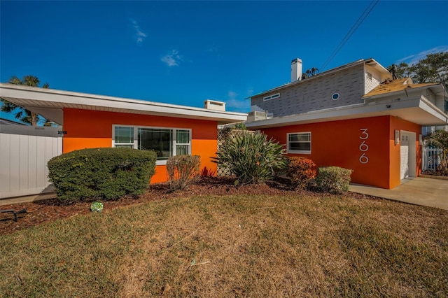 366 La Hacienda Dr, Indian Rocks Beach, FL 33785 - view of property exterior with stucco siding and a yard