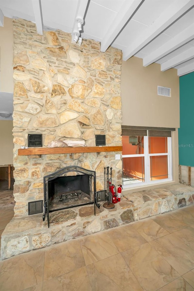 366 La Hacienda Dr, Indian Rocks Beach, FL 33785 - details with a fire extinguisher, beam ceiling, a stone fireplace, and visible vents