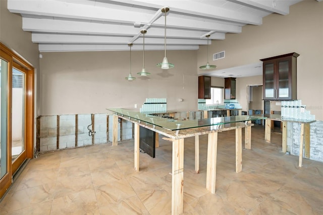 366 La Hacienda Dr, Indian Rocks Beach, FL 33785 - interior space featuring dark brown cabinetry, a sink, beamed ceiling, visible vents, and pendant lighting