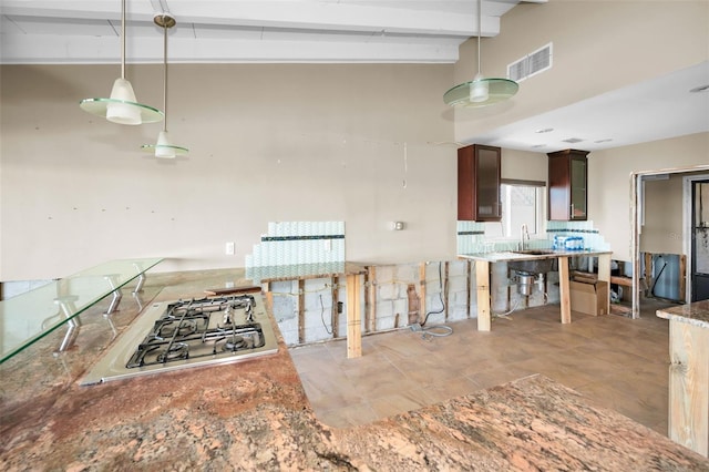 366 La Hacienda Dr, Indian Rocks Beach, FL 33785 - kitchen with visible vents, beam ceiling, a sink, decorative light fixtures, and stainless steel gas stovetop
