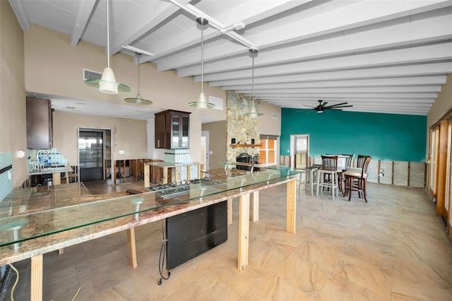 366 La Hacienda Dr, Indian Rocks Beach, FL 33785 - kitchen featuring visible vents, a fireplace, ceiling fan, decorative light fixtures, and stainless steel gas stovetop