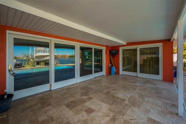 366 La Hacienda Dr, Indian Rocks Beach, FL 33785 - unfurnished sunroom featuring stone tile flooring