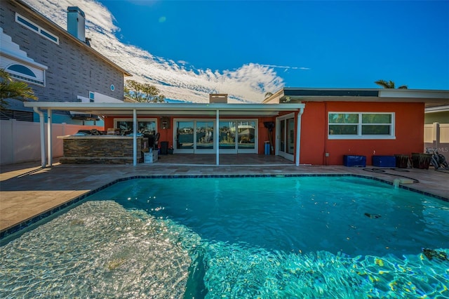 366 La Hacienda Dr, Indian Rocks Beach, FL 33785 - rear view of property with fence, a fenced in pool, a patio area, and stucco siding