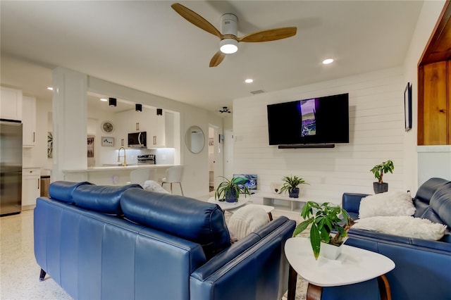 2488 Del Rio Way, Dunedin, FL 34698 - living area featuring a ceiling fan, wood walls, and recessed lighting
