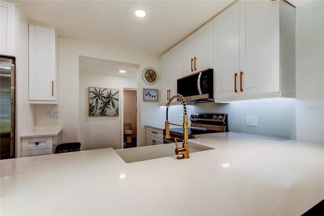 2488 Del Rio Way, Dunedin, FL 34698 - kitchen with stainless steel appliances, light countertops, recessed lighting, and white cabinets