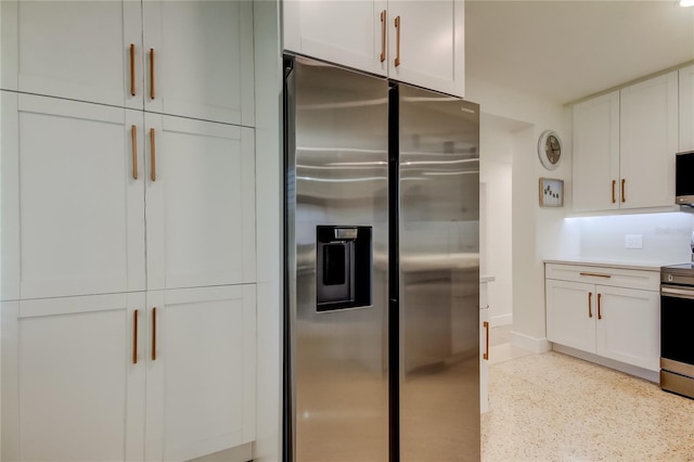2488 Del Rio Way, Dunedin, FL 34698 - kitchen featuring appliances with stainless steel finishes, dark speckled floor, white cabinetry, baseboards, and light countertops