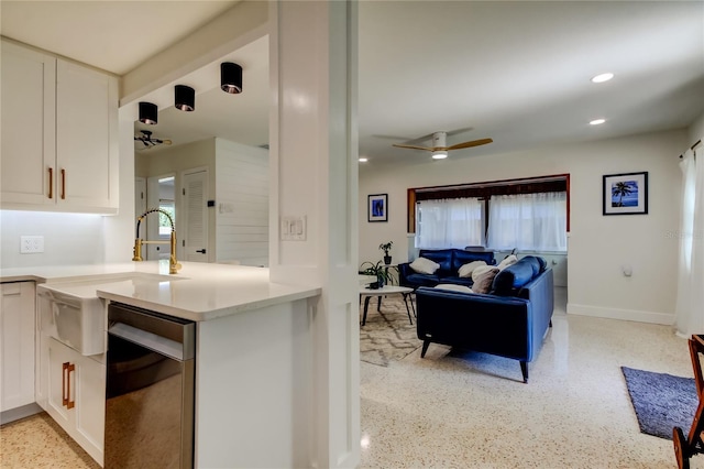 2488 Del Rio Way, Dunedin, FL 34698 - kitchen with ceiling fan, white cabinetry, light countertops, dark speckled floor, and recessed lighting