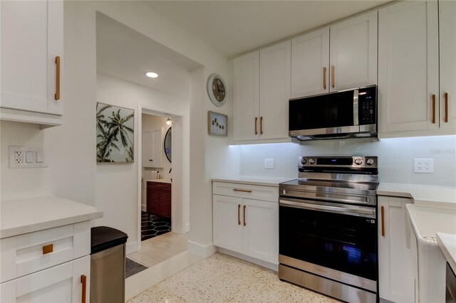 2488 Del Rio Way, Dunedin, FL 34698 - kitchen featuring appliances with stainless steel finishes, light countertops, white cabinetry, recessed lighting, and dark speckled floor