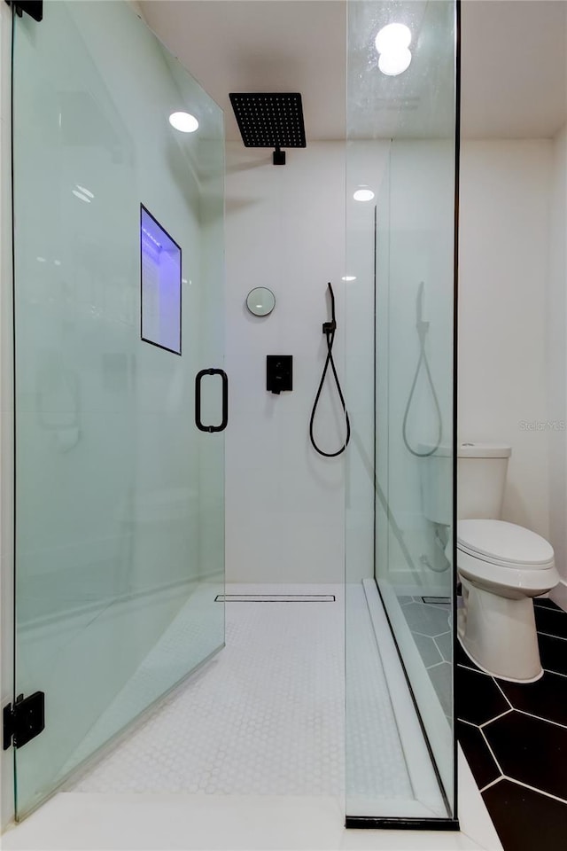 2488 Del Rio Way, Dunedin, FL 34698 - bathroom with a stall shower, toilet, and tile patterned floors