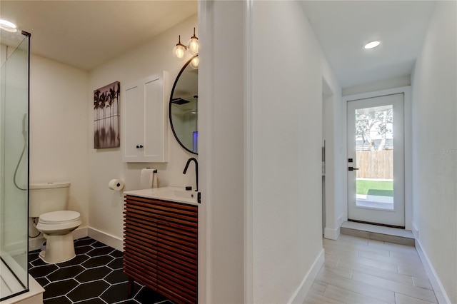 2488 Del Rio Way, Dunedin, FL 34698 - full bath featuring an enclosed shower, toilet, vanity, baseboards, and recessed lighting