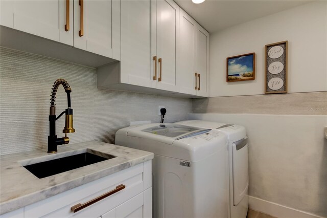 2488 Del Rio Way, Dunedin, FL 34698 - laundry room featuring washer and clothes dryer and cabinet space