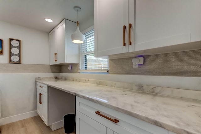2488 Del Rio Way, Dunedin, FL 34698 - kitchen with white cabinets, light stone counters, light wood finished floors, hanging light fixtures, and recessed lighting