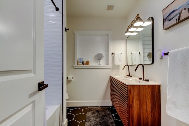 2488 Del Rio Way, Dunedin, FL 34698 - full bathroom featuring double vanity, tile patterned floors, and baseboards