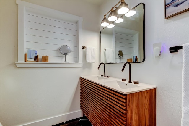 2488 Del Rio Way, Dunedin, FL 34698 - bathroom featuring double vanity, tile patterned floors, and baseboards