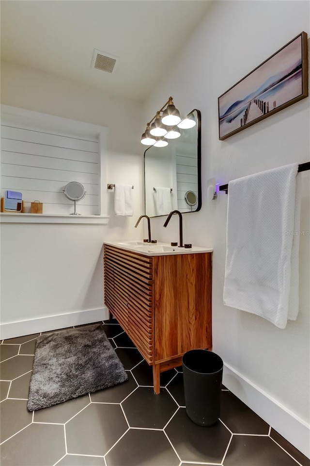 2488 Del Rio Way, Dunedin, FL 34698 - bathroom featuring vanity, baseboards, and tile patterned flooring