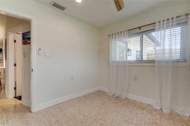 2488 Del Rio Way, Dunedin, FL 34698 - empty room featuring speckled floor and baseboards