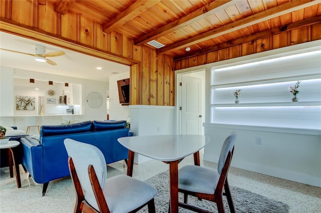 2488 Del Rio Way, Dunedin, FL 34698 - dining space with wooden ceiling with exposed beams, wooden walls, and speckled floor