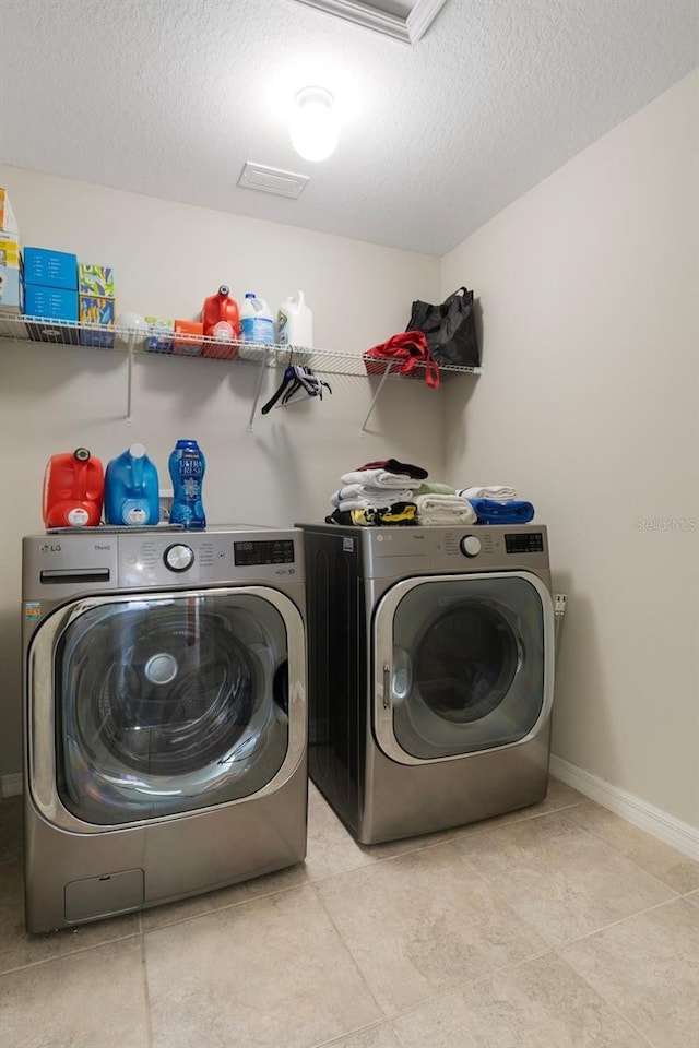 21046 Passive Porch Dr, Land O Lakes, FL 34637 - laundry room featuring a textured ceiling, baseboards, laundry area, and independent washer and dryer