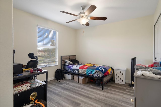 21046 Passive Porch Dr, Land O Lakes, FL 34637 - bedroom featuring baseboards, a ceiling fan, and light wood finished floors