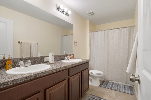 21046 Passive Porch Dr, Land O Lakes, FL 34637 - full bath with double vanity, a sink, tile patterned floors, and toilet