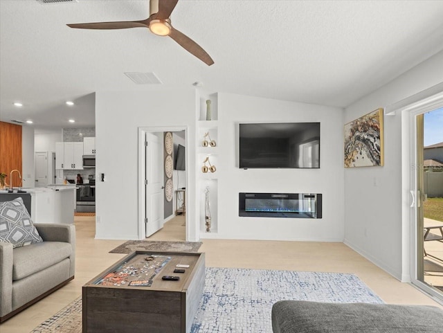 9617 Branching Ship Trce, Wesley Chapel, FL 33545 - living room featuring recessed lighting, light wood finished floors, visible vents, a ceiling fan, and a glass covered fireplace