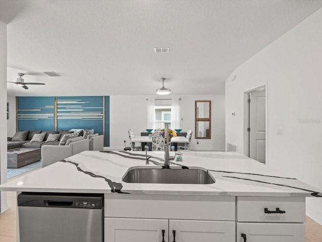 9617 Branching Ship Trce, Wesley Chapel, FL 33545 - kitchen featuring stainless steel dishwasher, a sink, open floor plan, visible vents, and white cabinetry