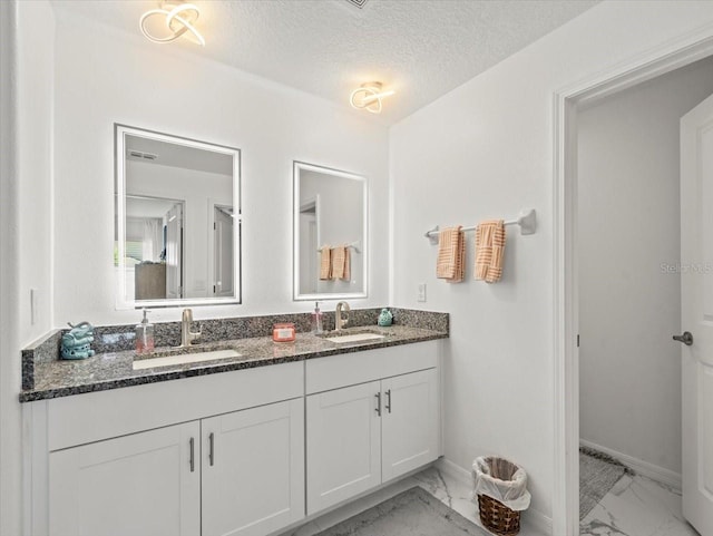 9617 Branching Ship Trce, Wesley Chapel, FL 33545 - bathroom featuring marble finish floor, a sink, and a textured ceiling
