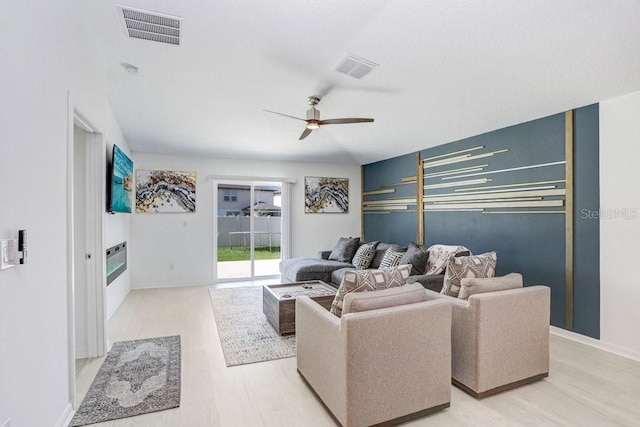 9617 Branching Ship Trce, Wesley Chapel, FL 33545 - living room with light wood-type flooring, visible vents, and ceiling fan