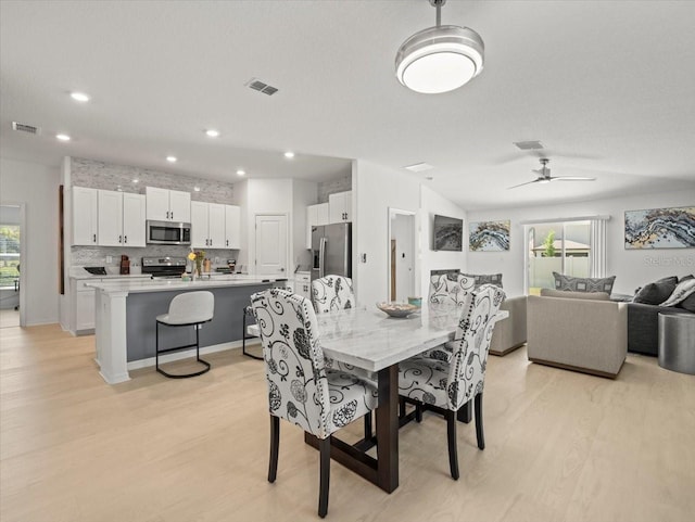 9617 Branching Ship Trce, Wesley Chapel, FL 33545 - dining space featuring plenty of natural light, visible vents, and light wood-style flooring