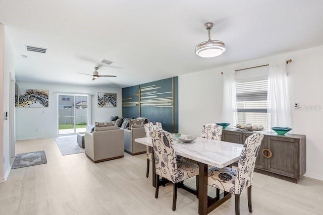 9617 Branching Ship Trce, Wesley Chapel, FL 33545 - dining room featuring light wood-type flooring, visible vents, a ceiling fan, and baseboards