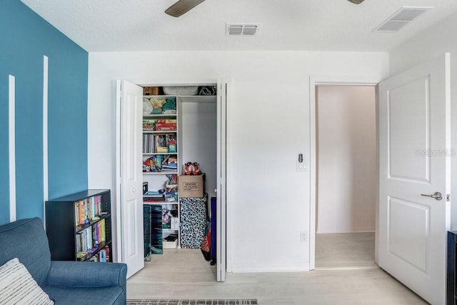 9617 Branching Ship Trce, Wesley Chapel, FL 33545 - living area featuring light wood-type flooring, a ceiling fan, and visible vents