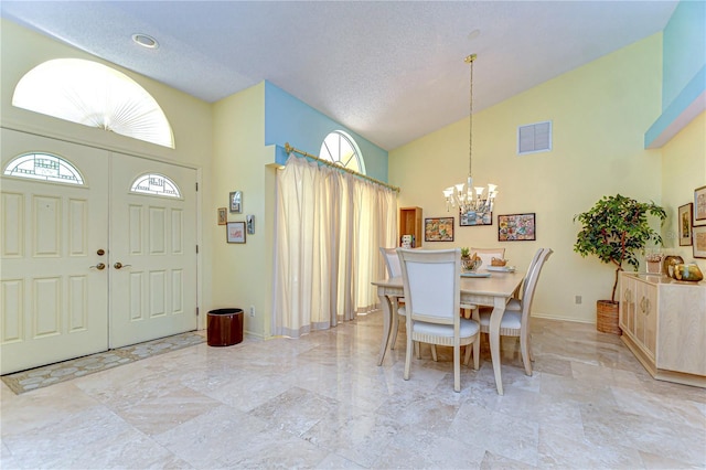 14119 Stonegate Dr, Tampa, FL 33624 - dining space featuring high vaulted ceiling, a chandelier, a textured ceiling, baseboards, and visible vents
