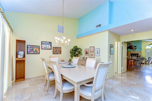 14119 Stonegate Dr, Tampa, FL 33624 - dining room featuring baseboards, visible vents, high vaulted ceiling, and an inviting chandelier