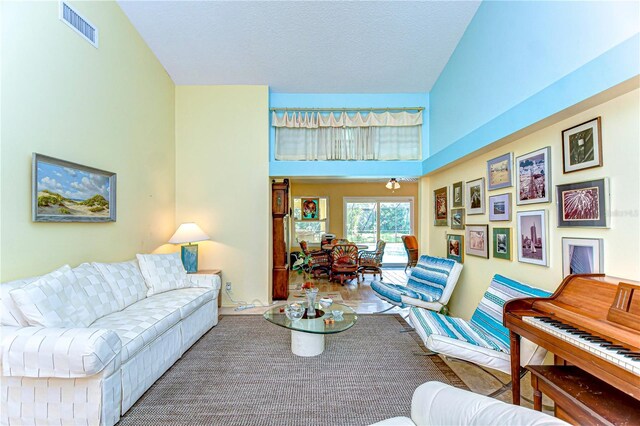 14119 Stonegate Dr, Tampa, FL 33624 - living area featuring a high ceiling, a textured ceiling, and visible vents