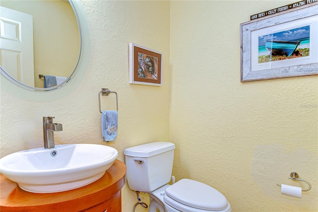 14119 Stonegate Dr, Tampa, FL 33624 - bathroom featuring toilet, vanity, and a textured wall