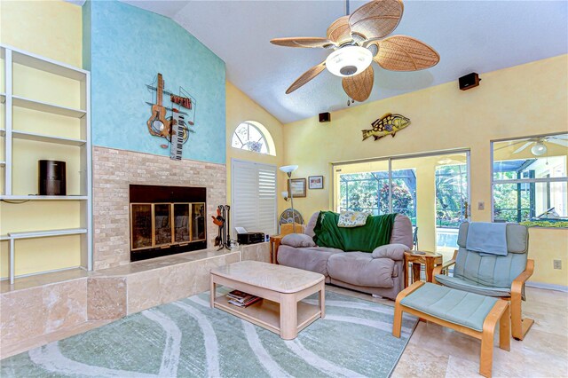 14119 Stonegate Dr, Tampa, FL 33624 - living area with built in features, high vaulted ceiling, a tiled fireplace, and a ceiling fan