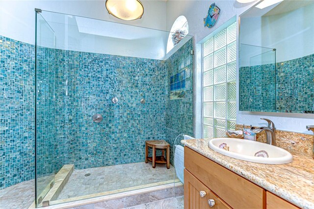 14119 Stonegate Dr, Tampa, FL 33624 - bathroom featuring a tile shower and vanity
