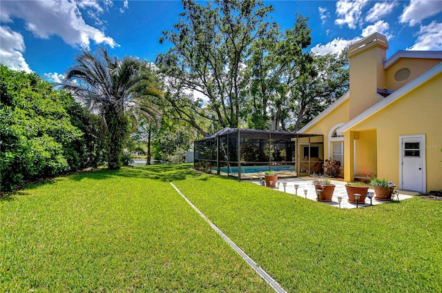 14119 Stonegate Dr, Tampa, FL 33624 - view of yard featuring an outdoor pool, glass enclosure, and a patio