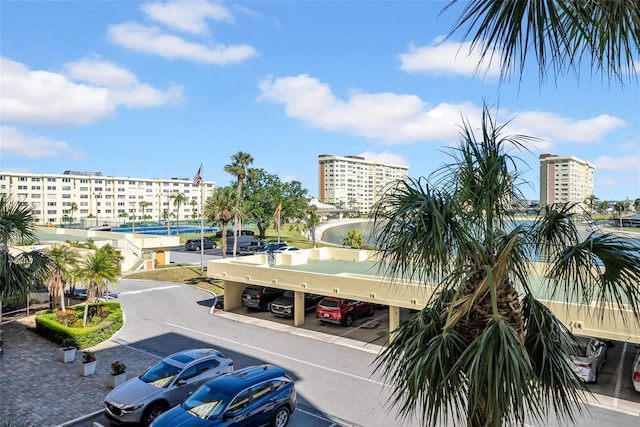 4725 Cove Cir Unit 302, Saint Petersburg, FL 33708 - view of property featuring covered and uncovered parking and a view of city