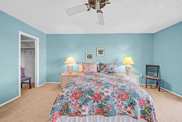 4725 Cove Cir Unit 302, Saint Petersburg, FL 33708 - bedroom featuring carpet floors, baseboards, a spacious closet, and a textured ceiling