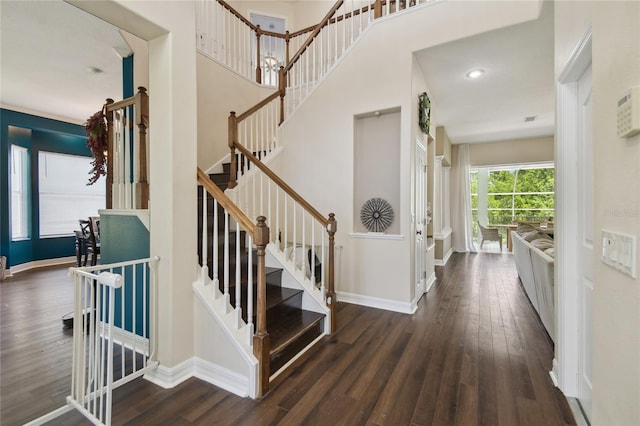 stairs with baseboards and wood finished floors