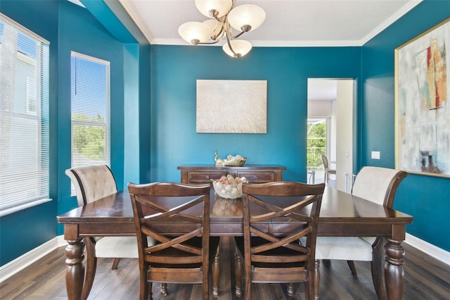 dining area featuring wood finished floors, baseboards, a chandelier, and ornamental molding