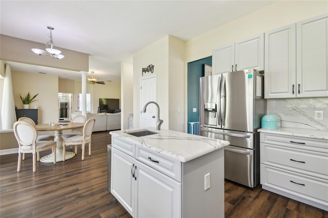 kitchen with white cabinets, stainless steel refrigerator with ice dispenser, a sink, and dark wood finished floors