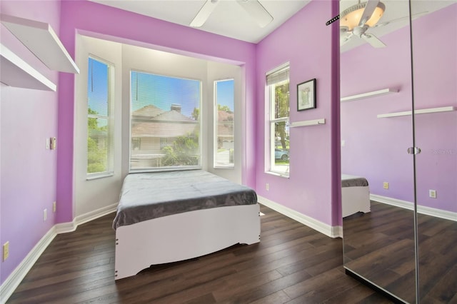 bedroom featuring hardwood / wood-style flooring, baseboards, and a ceiling fan