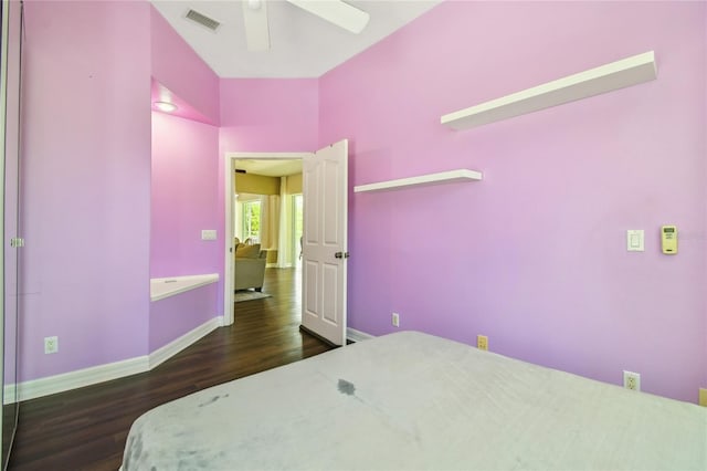 bedroom featuring dark wood finished floors, baseboards, a ceiling fan, and visible vents