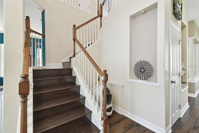 staircase with baseboards and hardwood / wood-style flooring