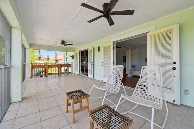 sunroom / solarium featuring ceiling fan
